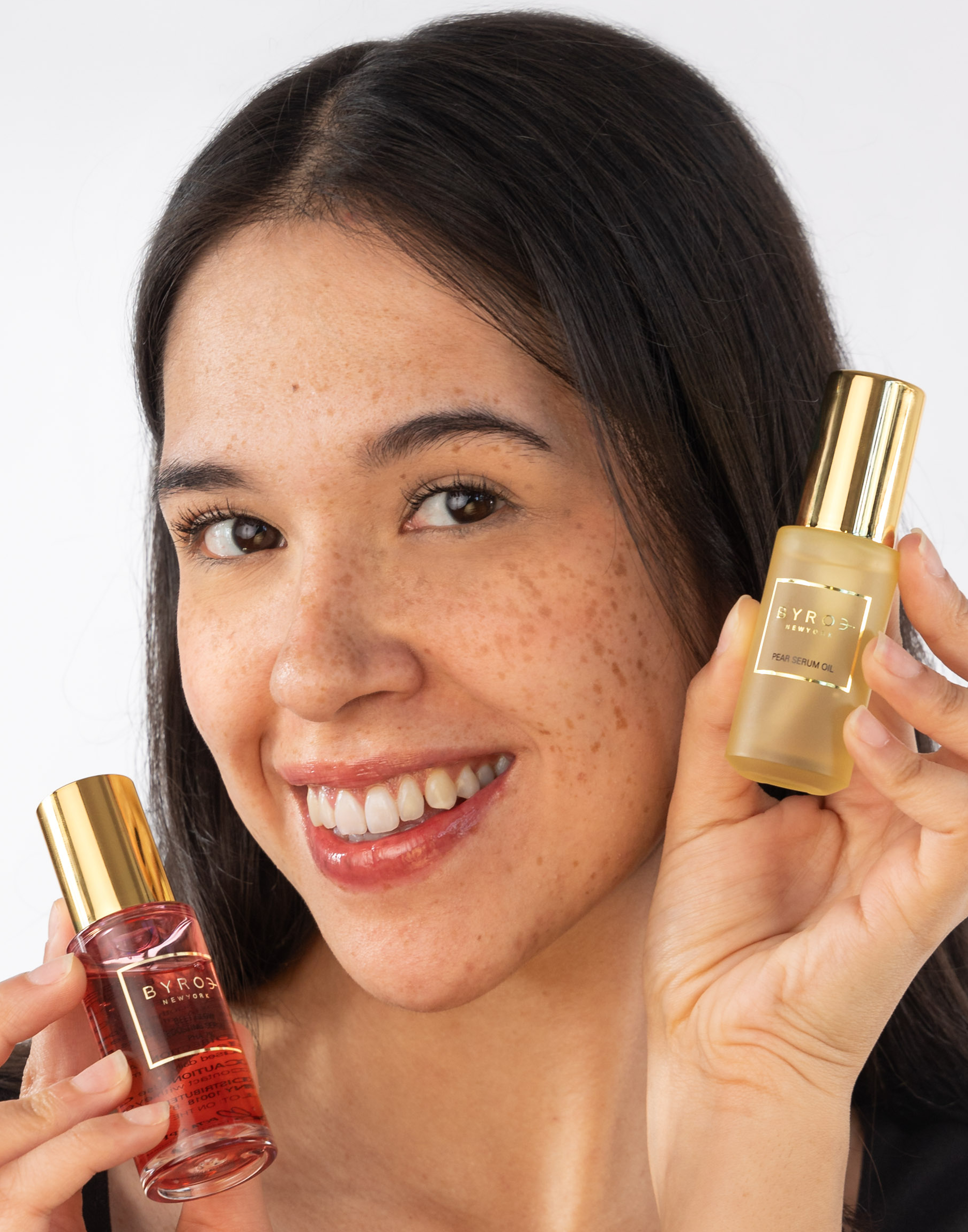 Photo of model holding Pear Serum Oil and Beet Glow Boosting Serum