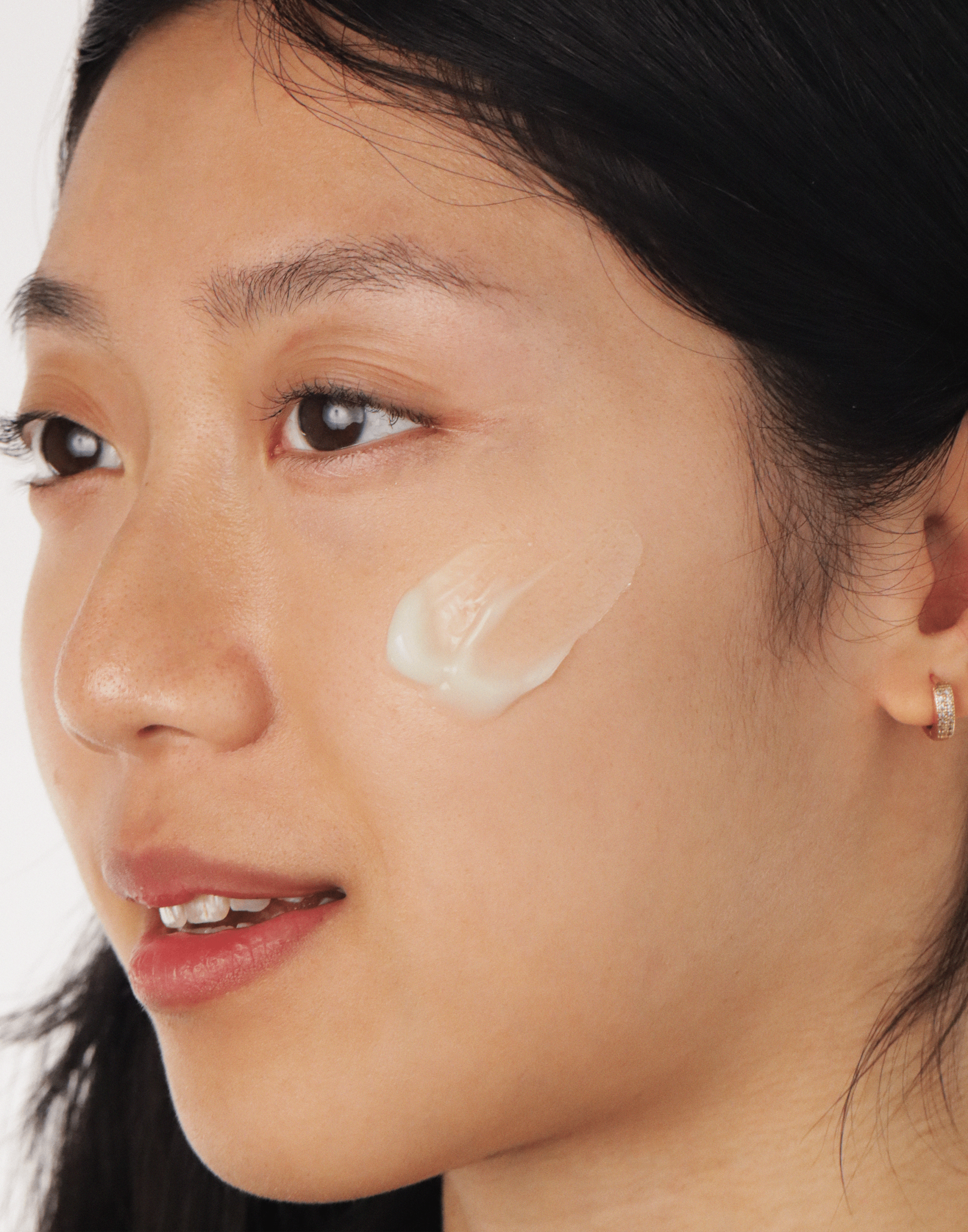 Photo of model with the texture of Kale Hydrating Gel Moisturizer on her cheek