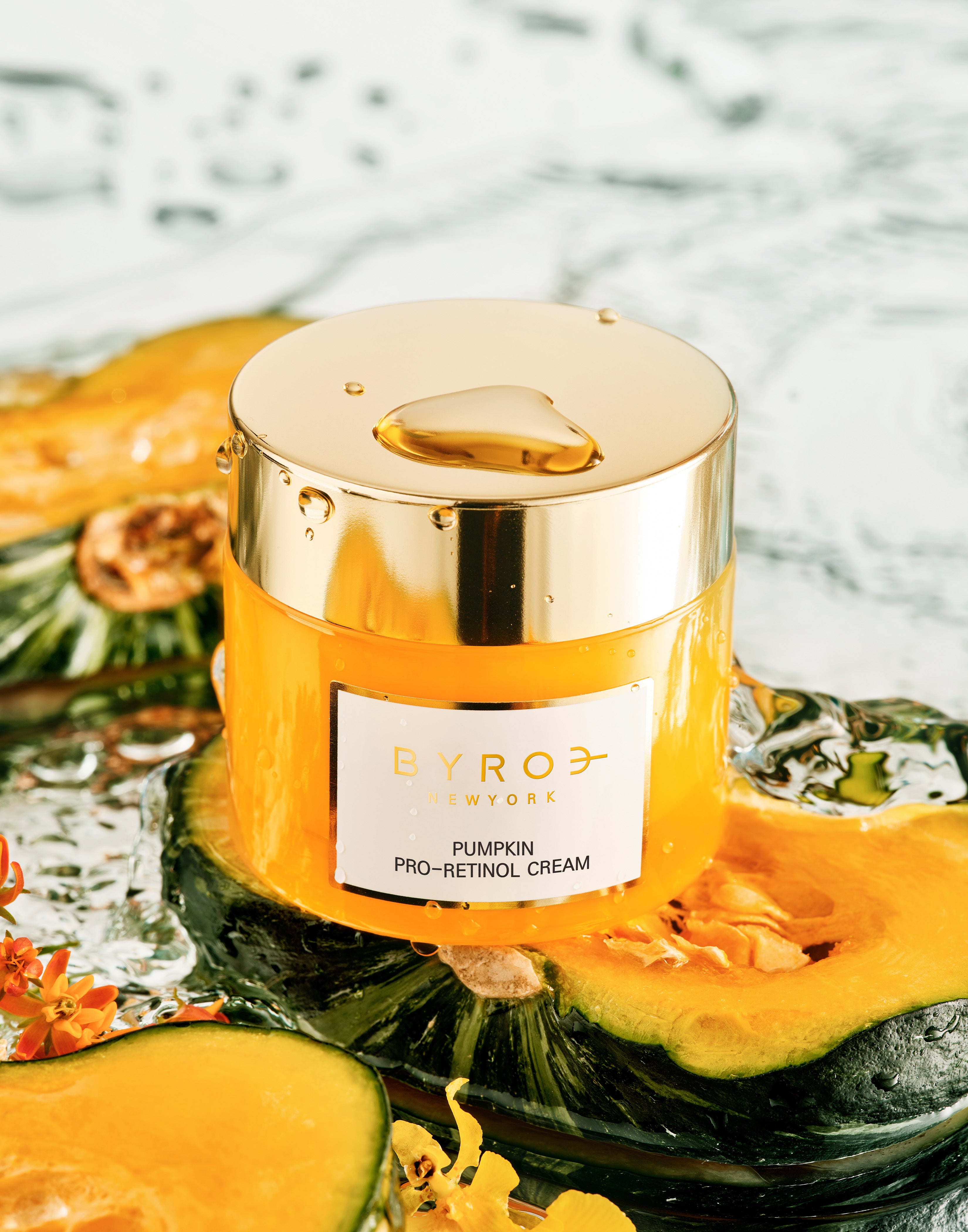 Photo of Pumpkin Pro-Retinol Cream on top of pumpkins in water